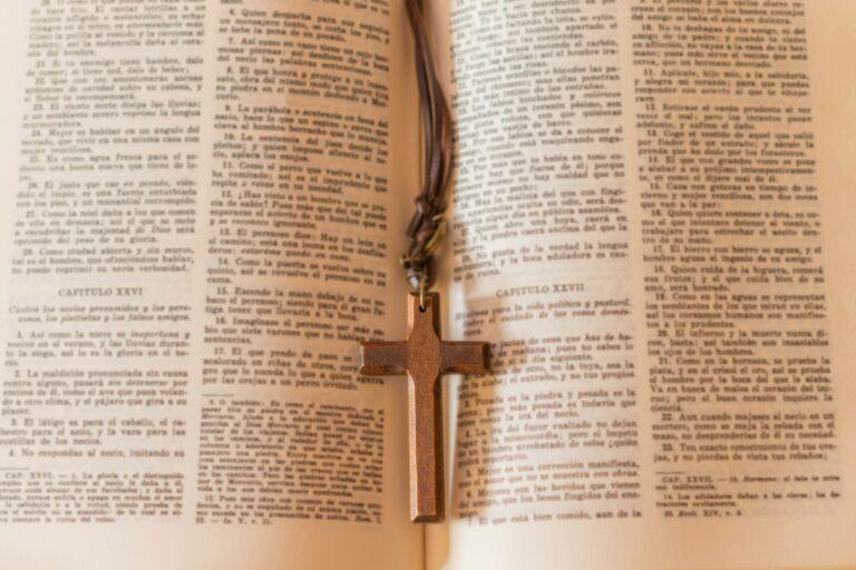 Wooden cross necklace on a page of the bible