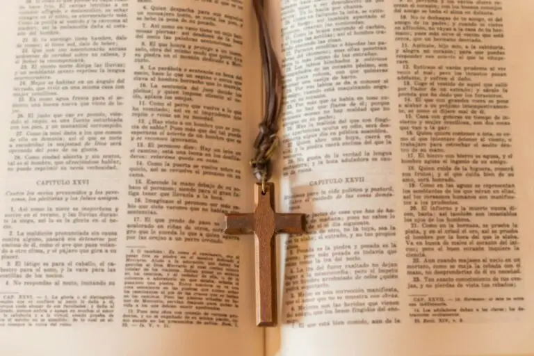Wooden cross necklace on a page of the bible
